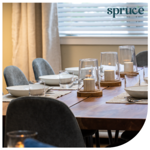 Image of dining table, image has a curved corner and is on a white background with Spruce logo in top right corner.