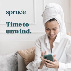 A woman in pajamas with her hair in white towel scheduling a Spruce cleaning on her phone app, with Spruce logo above text.