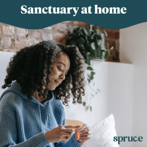 A woman knitting and smiling in her clean apartment. The words 'Sanctuary at home' are on the top of the image and the Spruce logo is in the bottom right corner.