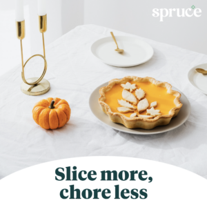 A table set with a candle, a pumpkin, and a pumpkin pie. Underneath the image it says 'Slice more, chore less.'