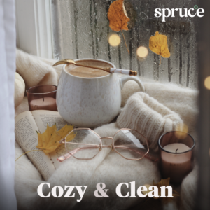 An image of a coffee mug near a rainy window. The words 'Cozy and clean' are at the bottom and the Spruce logo is in the top right.